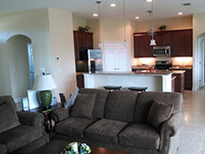 A large living area with adjoining kitchen.