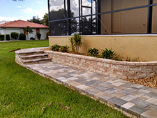A tile walkway in front of a luxury home